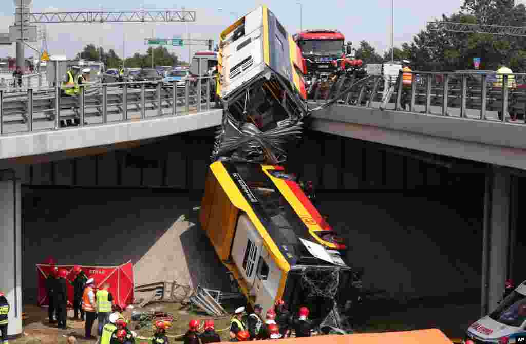 The wreckage of a Warsaw city bus is seen after it crashed off an overpass, killing one person and injuring about 20 people, in Warsaw, Poland.