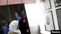 Survivors of the 1995 Srebrenica massacre look at a Dutch-designed exhibition that opened near the former U.N. safe base in Potocari near Srebrenica, Bosnia and Herzegovina, Feb. 9, 2017. 