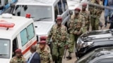 Kenyan security forces walk away from the hotel complex at the scene of the attack in Nairobi, Kenya, Jan. 16, 2019.