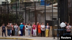 People wait in line to enter the U.S. embassy in Havana, Cuba, March 18, 2019. 