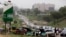 FILE - Cars queue up to buy fuel at a petrol station in Abuja, Nigeria, April 1, 2016. A series of bombings of pipelines and oil facilities have cut Nigeria's daily oil production of around two million barrels by as much as half.