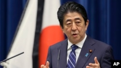 Japanese Prime Minister Shinzo Abe speaks to the media on the eve of the fifth anniversary of the March 11, 2011, earthquake and tsunami, in Tokyo, March 10, 2016. He pledged to bolster reconstruction efforts in northern Japan.