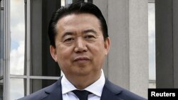 FILE - Then-Interpol chief Meng Hongwei poses during a visit to the headquarters of International Police Organization in Lyon, France, May 8, 2018. 