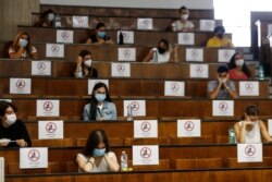 Students sit at a distance as a precaution against COVID-19, as they undergo an aptitude test to access the University of Medicine, in Rome Thursday, Sept. 3, 2020. The faculty of Medicine, as well as other University studies, in Italy require a…