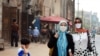 FILE - Uighur Muslim women wear headscarves while walking in China's Xinjiang Uighur Autonomous Region, June 14, 2008. China's crackdown on Islamic culture has spread to Hainan province, home to a small population of Utsuls, a Muslim ethnic group.