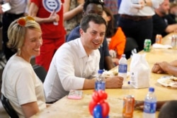 Democratic presidential candidate Pete Buttigieg speaks with local residents at the Hawkeye Area Labor Council Labor Day Picnic in Cedar Rapids, Iowa, Sept. 2, 2019.