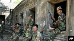 Cambodian soldiers sit at Preah Vihear temple after a brief clash with Thai troops, February 05, 2011