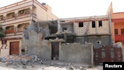 Damage to a house is seen following clashes between rival militias in the Janzour district on the outskirts of Tripoli, August 5, 2014. 