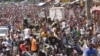 People celebrate in the streets with members of Guinea's armed forces after the arrest of President Alpha Conde in a coup d'etat in Conakry, Sept. 5, 2021.