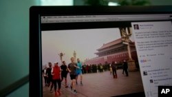A computer screen displays the social media posting by Mark Zuckerberg on Facebook in Beijing, China, Friday, March 18, 2016. The photo of Facebook founder Mark Zuckerberg jogging in downtown Beijing’s notorious smog has prompted a torrent of astonishment