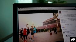 A computer screen displays the social media posting by Mark Zuckerberg on Facebook in Beijing, China, Friday, March 18, 2016.