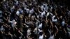 People display opened palm with five fingers, signifying the five demands of anti-government protesters during a march at Central district in Hong Kong, Wednesday, Oct. 2, 2019.