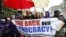 FILE - AFL-CIO Secretary-Treasurer Liz Shuler, center, joins protestors as they march in Washington, May 17, 2010, during a rally against Wall Street and corporate and anti-immigrant lobbyists.