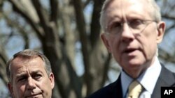 House Speaker John Boehner listens at left, as Senate Majority Leader Harry Reid speaks to reporters outside the White House, April 7, 2011