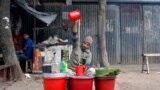 A street vendor prepares herbal juice for sale in Dhaka, Bangladesh.