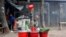 A street vendor prepares herbal juice for sale in Dhaka, Bangladesh.