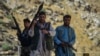 Afghan resistance movement and anti-Taliban uprising forces patrol along a road at the Rah-e Tang in Panjshir province on August 25, 2021, following Taliban's military takeover of Afghanistan. 