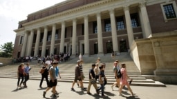 FILE - People walk past Widener Library, on the campus of Harvard University, in Cambridge, Massachusetts, July 16, 2019. Enrollment of international students is up following a drop during the pandemic, a 2022 report shows. 