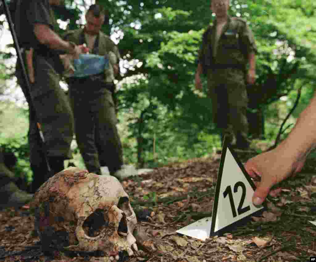 Photo shows a Finnish forensic expert placing a number next to the skull of a Srebrenica victim found in the hills above the village of Kravice, some 15 kms (10 miles) north west of Srebrenica.(File 2006)