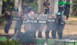 FILE - This screengrab provided via AFPTV and taken from a broadcast by Myitkyina News Journal on March 27, 2021, shows security forces cracking down on protesters during a demonstration against the military coup in Myanmar's Kachin state.