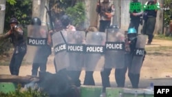 This screengrab provided via AFPTV and taken from a broadcast by Myitkyina News Journal on March 27, 2021 shows security forces crack down protesters during a demonstration against the military coup in Myitkyina in Myanmar's Kachin state.