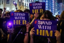 People hold placards and light up their smartphones as they take part in a rally at the financial district in Hong Kong, Aug. 28, 2019. Several thousand people protest against what they called sexual violence by the police.