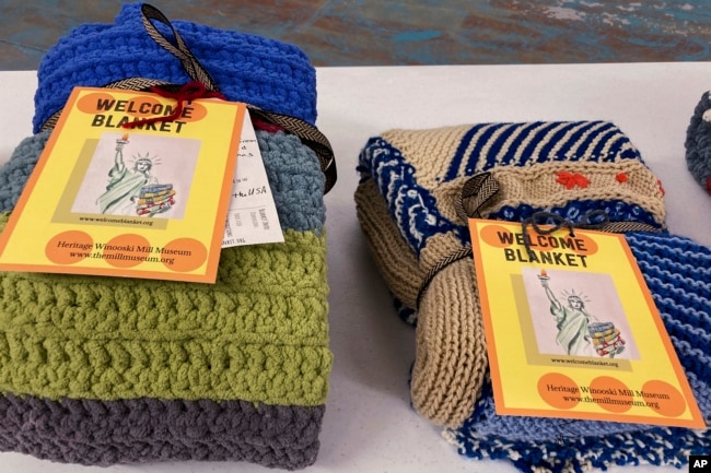 Handmade blankets for refugees sit on a table at a Welcome Blanket giveaway at the Association of Africans Living in Vermont, March 21, 2023, in Burlington, Vt. (AP Photo/Lisa Rathke)