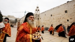 Greek Orthodox priests take part in the Christian Orthodox Christmas Eve celebrations at the Church of the Nativity, traditionally believed by Christians to be the birthplace of Jesus Christ, in the West Bank city of Bethlehem, Jan. 6, 2015. 