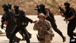 FILE - Special operations forces from Iraq, Jordan and the U.S. conduct a joint exercise.