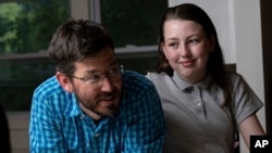 Jay Wamsted, left, and his daughter, Kira, are photographed on Thursday, May 20, 2021 in Smyrna, Ga. Wamsted, who is an 8th grade math teacher, allowed his daughter to skip testing this year. (AP Photo/Ben Gray)