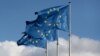 FILE PHOTO: European Union flags fly outside the EU Commission headquarters in Brussels