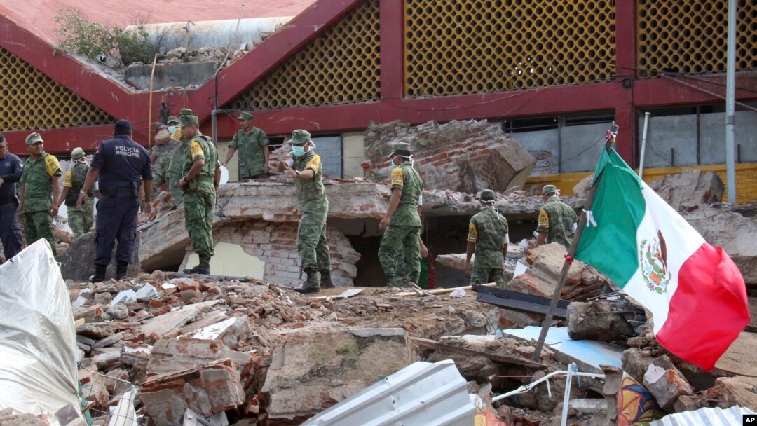 Soldiers remove debris from a partly collapsed municipal building felled by a massive earthquake in Juchitan, Oaxaca state, Mexico, Friday, Sept. 8, 2017. One of the most powerful earthquakes ever to strike Mexico has hit off its southern Pacific coast, k