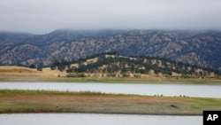 FILE - Lake Berryessa is seen with parts of California's newest national monument in the background, July 10, 2015, near Berryessa Snow Mountain National Monument, California.