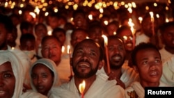 FILE - Ethiopian Orthodox faithful hold candles during a Christmas Eve celebration at Bole Medhanialem Church in Addis Ababa, Ethiopia, January 6, 2024.
