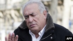 Former International Monetary Fund chief Dominique Strauss-Kahn gestures as he leaves a restaurant in Paris, December 11, 2012.