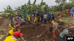 FILE —Villagers and volunteers dig looking for human remains of victims of the 1994 Rwandan Genocide hidden under the foundations of a house in Ngoma, Rwanda on January 23, 2023, where more than 82 bodies have been found since January 21, 2024.