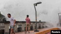 A person takes photos of the waves as Typhoon Krathon approaches in Kaohsiung, Taiwan, Oct. 2, 2024. 