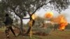 SYRIA -- Members of Syria's opposition "National Liberation Front" fire heavy artillery guns at government forces in northeastern Idlib province, February 28, 2020