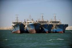 FILE - Chinese fishing vessels are seen moored off the coast of Nouadhibou, Mauritania, April 14, 2018.