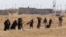 Syrian refugees depart border area after waiting for several hours in failed bid to enter Akcakale, Sanliurfa province, Turkey, June 12, 2015.