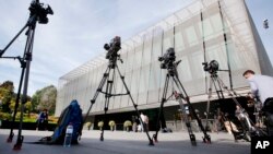 FILE - TV cameras stand outside the FIFA headquarters after a meeting of the FIFA Executive Committee in Zurich, Switzerland, Sept. 25, 2015.