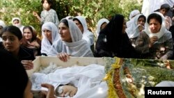 FILE - Relatives of slain Afghan journalist Zakia Zaki, 35, mourn her death, Parwan province, June 6, 2007.