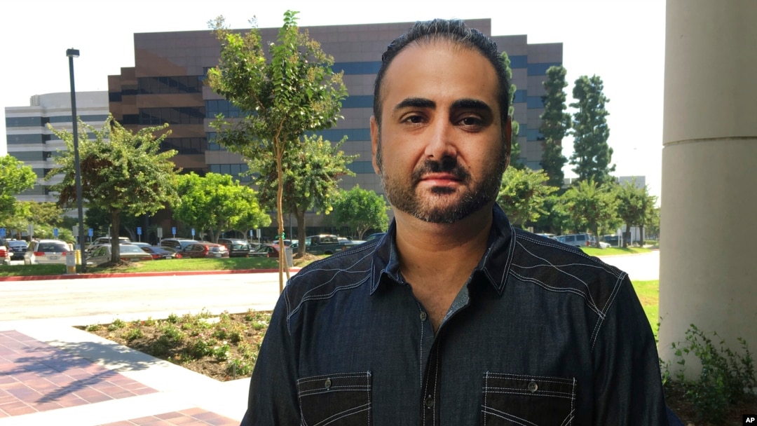 U.S. Navy veteran Mohammed Jahanfar poses for a photo during an interview on Sept. 27, 2017, in Long Beach, Calif. Jahanfar, is seeking a visa to bring his Iranian fiancée to live with him in California, and fears that may not be possible now.