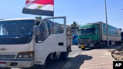 Humanitarian aid convoy for the Gaza Strip is parked in Arish, Egypt, Oct. 16, 2023. 