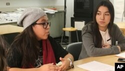 In this photo taken Dec. 1, 2016, Mexican students Yatziri Tovar, left, and Roxanna Herrera, discuss their travel plans at City College of New York.