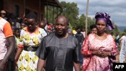 Evariste Ndayishimiye (2nd R), Burundi's Presidential candidate of the ruling party CNDD-FDD, and his wife Angelique Ndayubaha (R) arrive to vote during the presidential and general elections at the Bubu Primary school in Giheta, May 20, 2020.