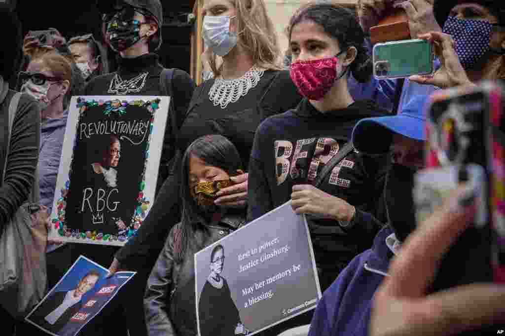 People gather during a public remembrance to honor the life and legacy of U.S. Supreme Court Justice and former Brooklynite Ruth Bader Ginsburg, outside Brooklyn&#39;s, Municipal Building, New York, Sept. 20, 2020.
