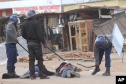 FILE: Police beating up protesters in Zimbabwe.