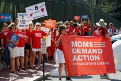 FILE - In this July 9, 2019 file photo, Moms Demanding Action line up during a rally at the State Capitol in Richmond, Va.