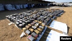 Blocks of confiscated cocaine are seen at a stone coal storage in Trujillo August 26, 2014, in this handout provided by the Peruvian Presidential Palace. 